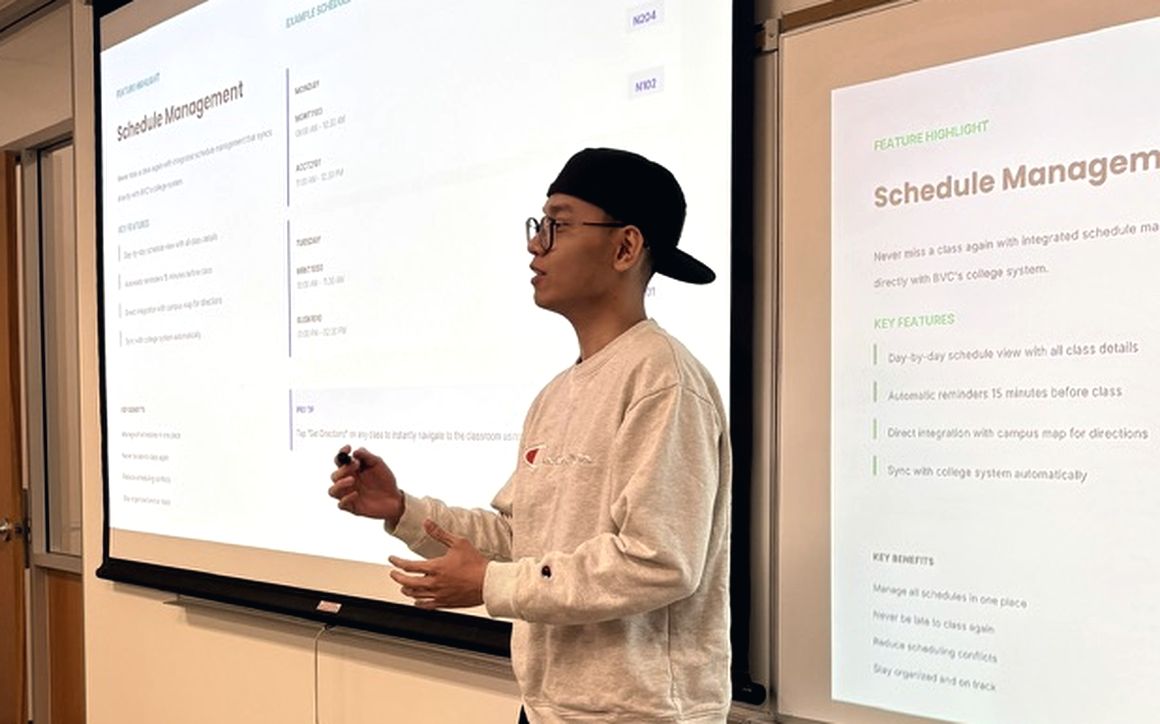 Dani Tran presenting a schedule management feature to a room at Bow Valley College